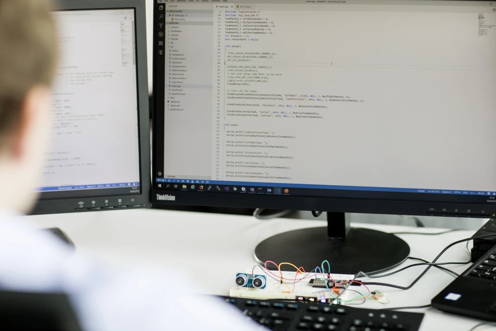 Over Shoulder View of a man sitting infront of a computer | SPIRIT/21